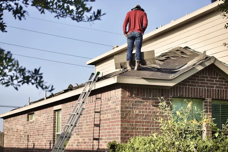 Professional roofer working on a residential roof in Toluca Lake